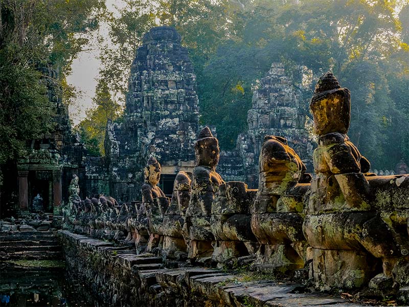 Statues lining a wall at one of the many temples of Siem Reap, Cambodia
