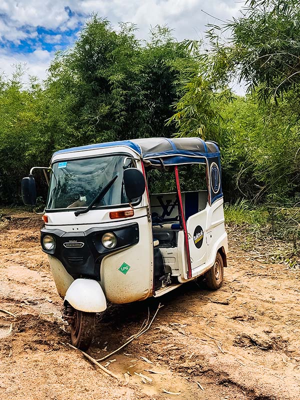 Matt driving a tuktuk through bad road conditions in Cambodia