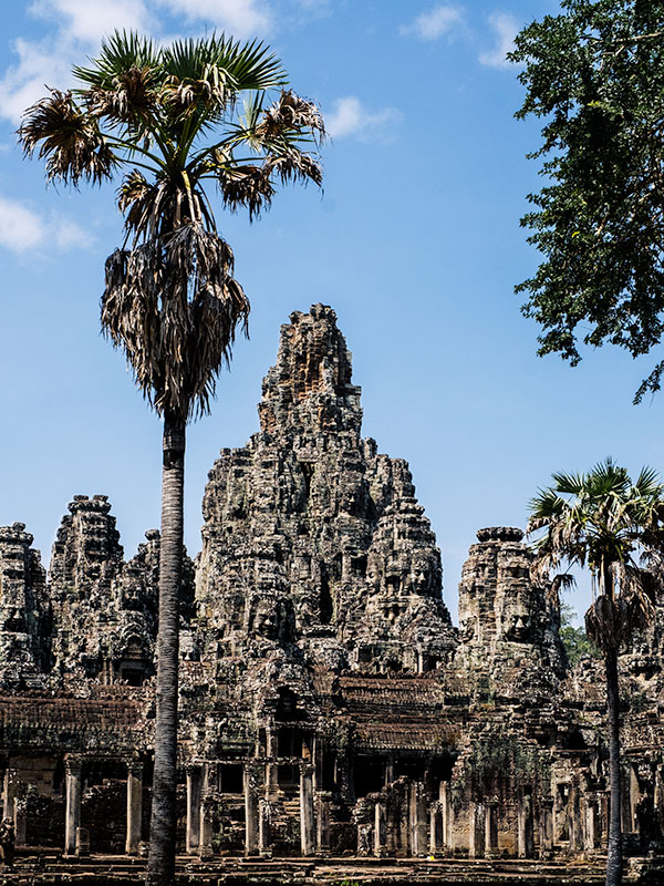 Exterior of Bayon Temple, Siem Reap framed by large trees