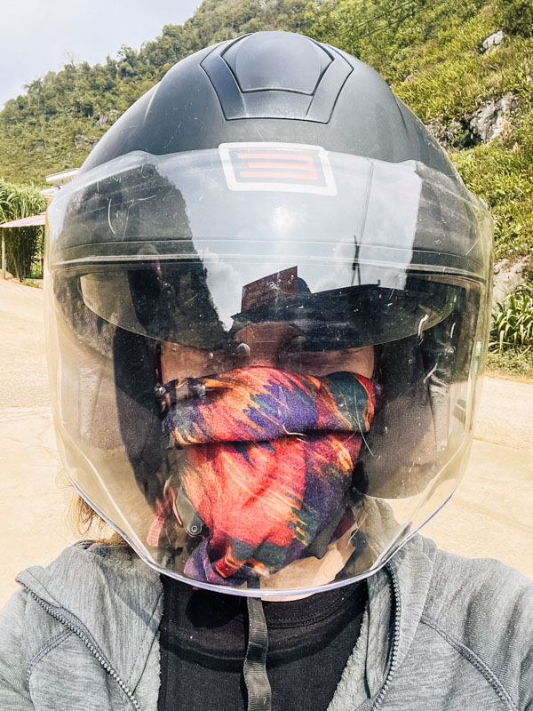 Katie facing the camera wearing a good quality helmet and a buff to cover mouth and nose