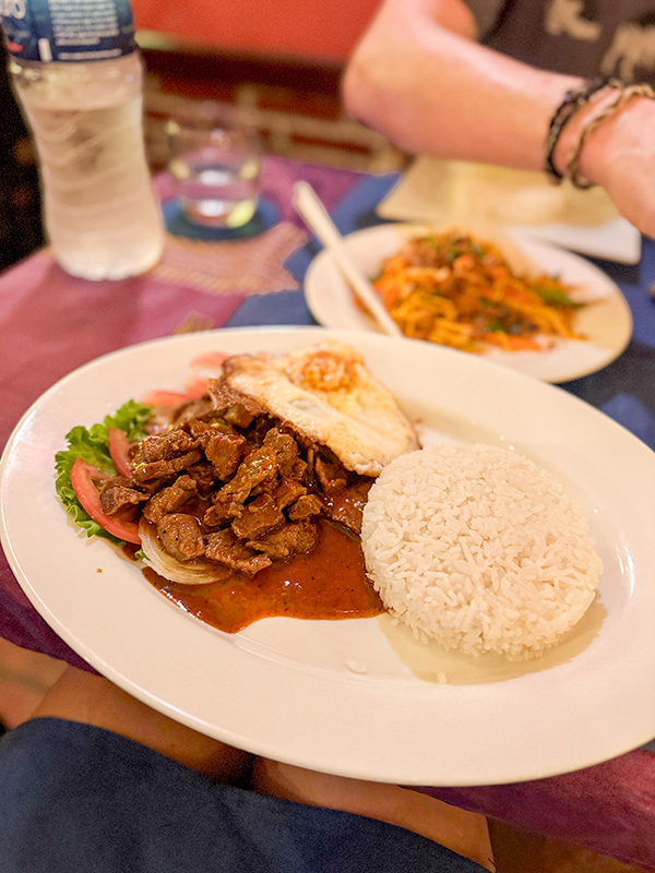 Cambodian lok lak (saucy beef dish) with rice, fried egg and salad