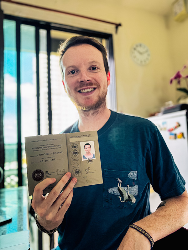 Matt holding his 1949 International Driving Permit (IDP)
