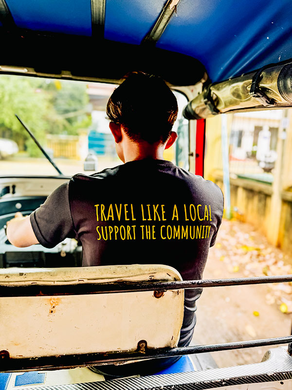 Tuktuk driving lesson in Siem Reap, driver's t-shirt says 'travel like a local, support the community'